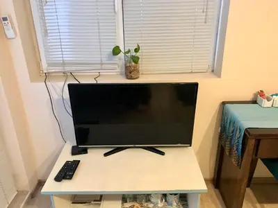a computer monitor sitting on a desk with a keyboard at Ssenyange Guest House in Varna City