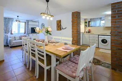 a kitchen and dining room with a table and chairs at Villa Baywatch in Galata