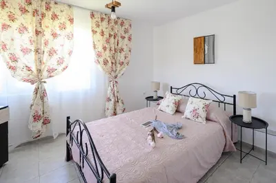 a bedroom with a bed with a stuffed animal on it at Villa Baywatch in Galata