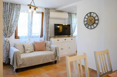 a living room with a couch and a tv at Villa Baywatch in Galata