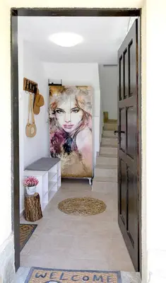 a hallway with a painting of a woman at Villa Baywatch in Galata