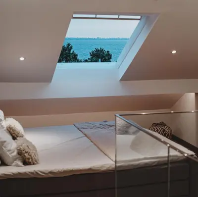 a bedroom with a bed with a window at Sunset Apartment in Pomorie