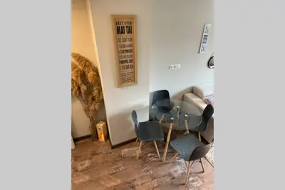 a living room with chairs and a table and a couch at Sunset Apartment in Pomorie
