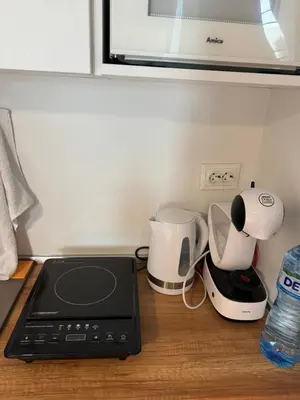 a kitchen counter with a coffee maker and a blender at Markoni 2 in Burgas City