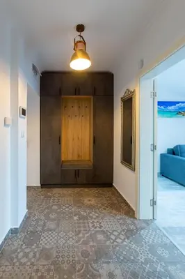 an empty room with a door and a blue couch at Seaman's house in Burgas City