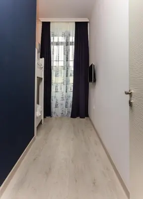 a room with a hallway with a door and a window at Seaman's house in Burgas City