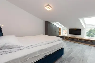 a bedroom with a bed and a flat screen tv at Seaman's house in Burgas City