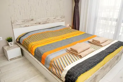 a bed with towels on it in a room at Charisma apt - lux at top city center in Varna City