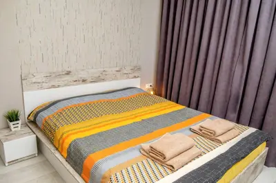 a bedroom with a bed with towels on it at Charisma apt - lux at top city center in Varna City
