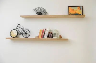 a shelf with a bike and books on a wall at Charisma apt - lux at top city center in Varna City