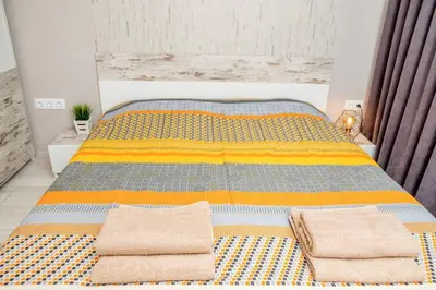 a bedroom with a bed with two towels on it at Charisma apt - lux at top city center in Varna City