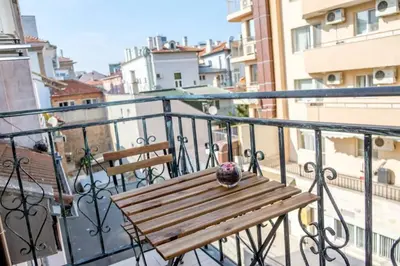 a wooden bench sitting on top of a balcony at Charisma apt - lux at top city center in Varna City