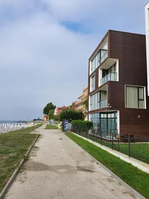 an empty sidewalk in front of a brick building at AMARA-BOUTIQUE & DESIGN - Студио in Ravda