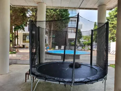 a trampoline in front of a swimming pool at AMARA-BOUTIQUE & DESIGN - Студио in Ravda