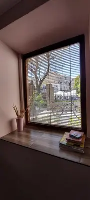 a room with a window with books and a plant at Guest house Dimant in Burgas City