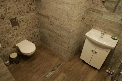 a bathroom with a white sink and a toilet at Guest house Dimant in Burgas City