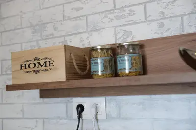 a wooden shelf with three jars of home spices at Guest house Dimant in Burgas City