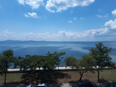 a view of the water from a parking lot at Стаи за гости WEST in Pomorie