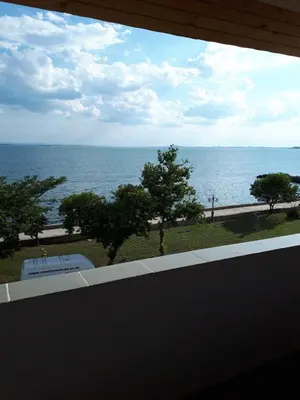 a view of the ocean from a balcony at Стаи за гости WEST in Pomorie
