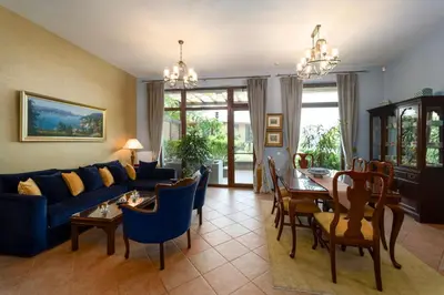 a living room with a blue couch and a table at Luxury 3-bedroom villa in Sozopolis with sea view in Sozopol