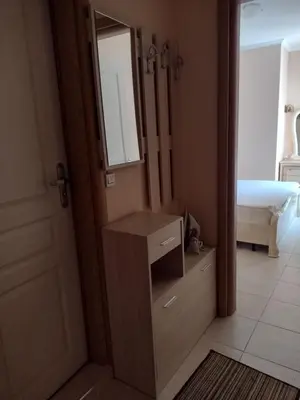 a bedroom with a dresser and a mirror and a bed at Messembria Resort in Sunny Beach