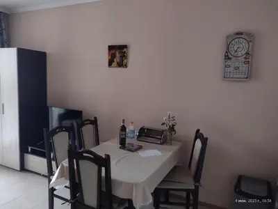 a dining room table with a table and a clock on the wall at Messembria Resort in Sunny Beach