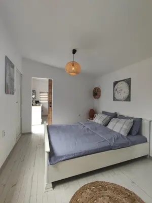 a bedroom with a large bed with blue sheets at La Veranda къща за гости Царево in Tsarevo