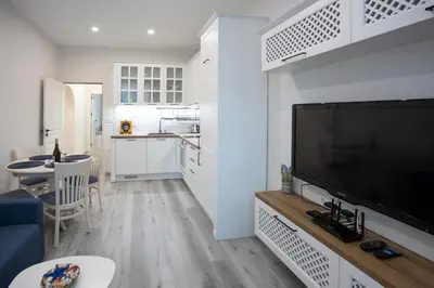 a living room with a large flat screen tv at Апартамент за гости Стела in Burgas City