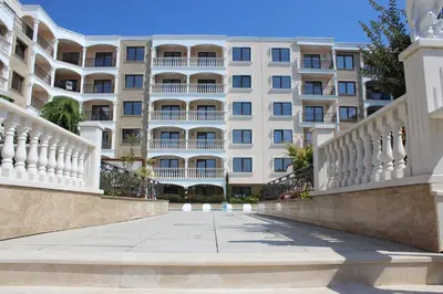 a large white building with a walkway in front of it at Valencia Gardens Luxury Studios in Nesebar