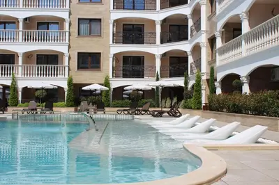 a swimming pool in front of a building at Valencia Gardens Luxury Studios in Nesebar