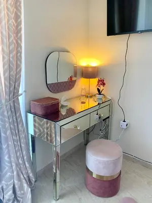 a dressing table with a mirror and a stool at Beige-a-view, Sea Dreams in Sveti Vlas