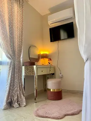 a room with a desk and a tv and a mirror at Beige-a-view, Sea Dreams in Sveti Vlas