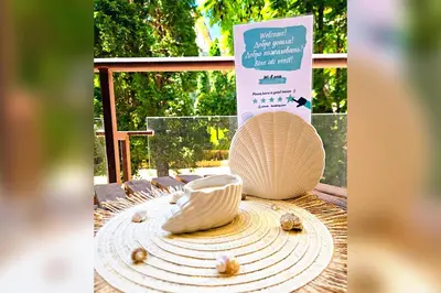 a table topped with shells on top of a table at Helios Studio in a Complex in St Vlas by Flat Mаnаger in Sveti Vlas