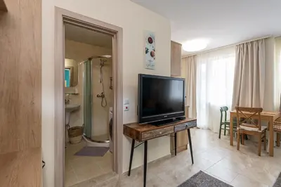 a living room with a flat screen tv on a table at Turquoise in Pomorie