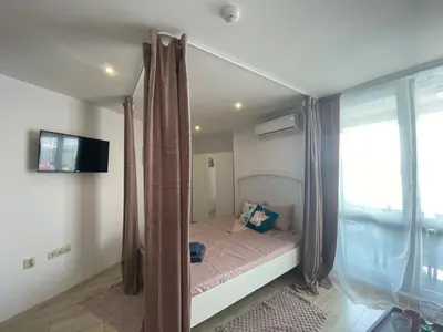 a small bed in a room with a window at PARADISO 'В' 109 Large Cozy Studio NESEBAR in Nesebar