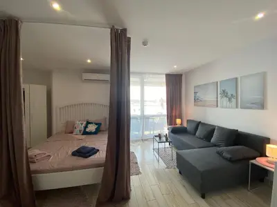 a living room with a bed and a couch at PARADISO 'В' 109 Large Cozy Studio NESEBAR in Nesebar