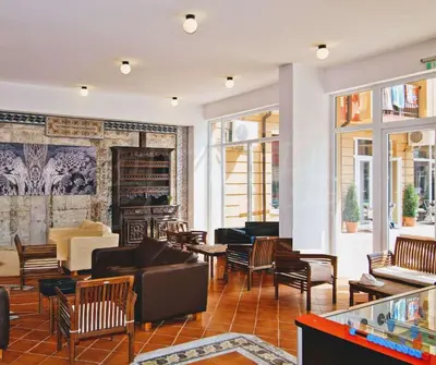 a lobby with a couch and chairs and a fireplace at Sunny View Central - Menada Apartments in Sunny Beach