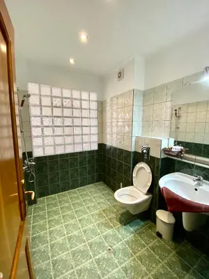 a bathroom with a toilet and a sink at Family Hotel The Golden fish in Sozopol