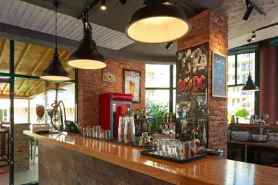 a bar in a restaurant with a brick wall at Pollo Resort, Summer Wind Apartaments in Sunny Beach