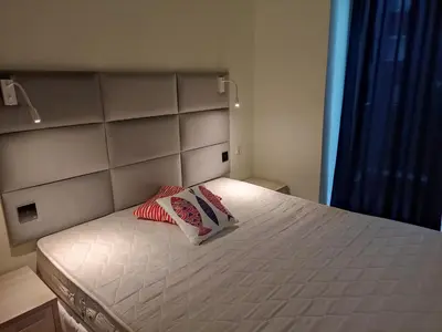 a bedroom with a bed with two pillows on it at Pollo Resort, Summer Wind Apartaments in Sunny Beach