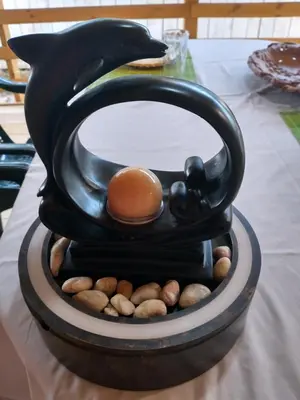 a black bird sculpture on a table with peanuts at каравана Марбея in Chernomorets