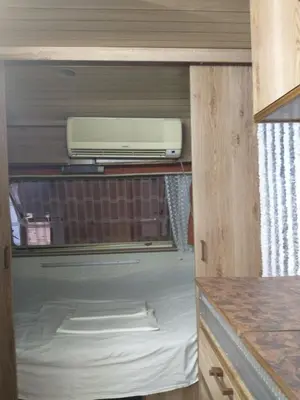 a appliance sitting on a shelf in a kitchen at каравана Марбея in Chernomorets