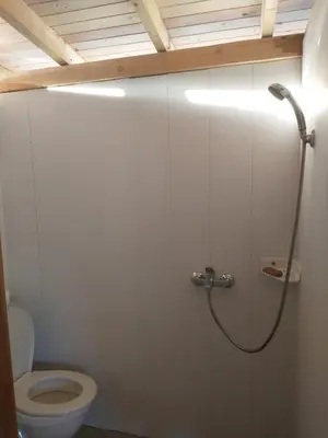 a bathroom with a toilet and a shower stall at каравана Марбея in Chernomorets
