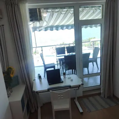 a laptop on a desk in a room with a balcony at Silver A28 in Byala