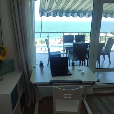 a desk with a laptop on it with a view of the ocean at Silver A28 in Byala