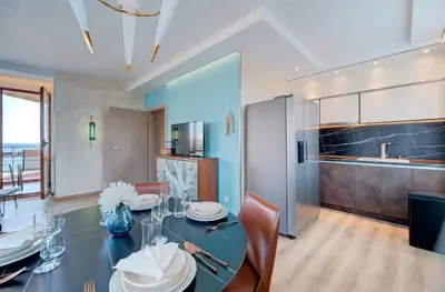 a kitchen and dining room with a table and chairs at Beachfront Smart Homes by Marty's in Sunny Beach