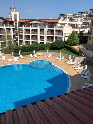 a large swimming pool in front of a large building at Paradise Dreams apartment in Sveti Vlas