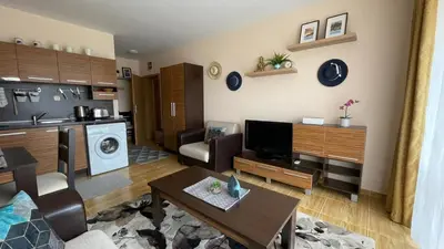a living room with a kitchen and a living room with a table at Paradise Dreams apartment in Sveti Vlas