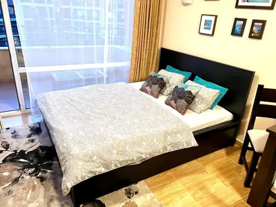 a bedroom with a bed with pillows and a window at Paradise Dreams apartment in Sveti Vlas