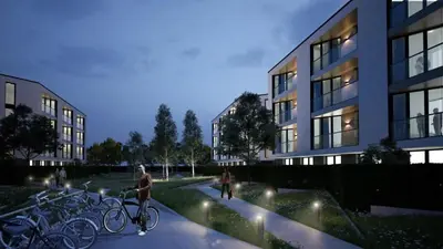 a man riding a bike on a sidewalk next to buildings at Atlantis Atmosphere Apartment in Burgas City